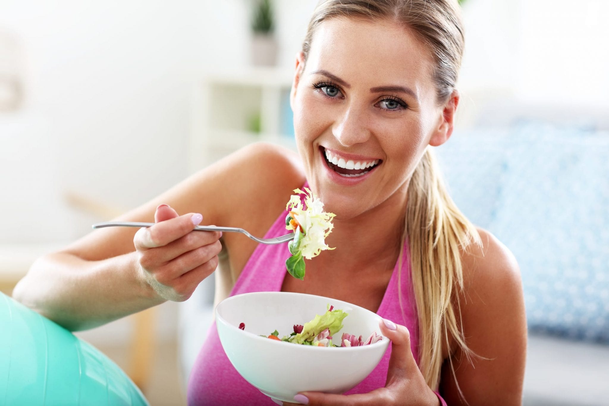 Woman Eating And Smiling
