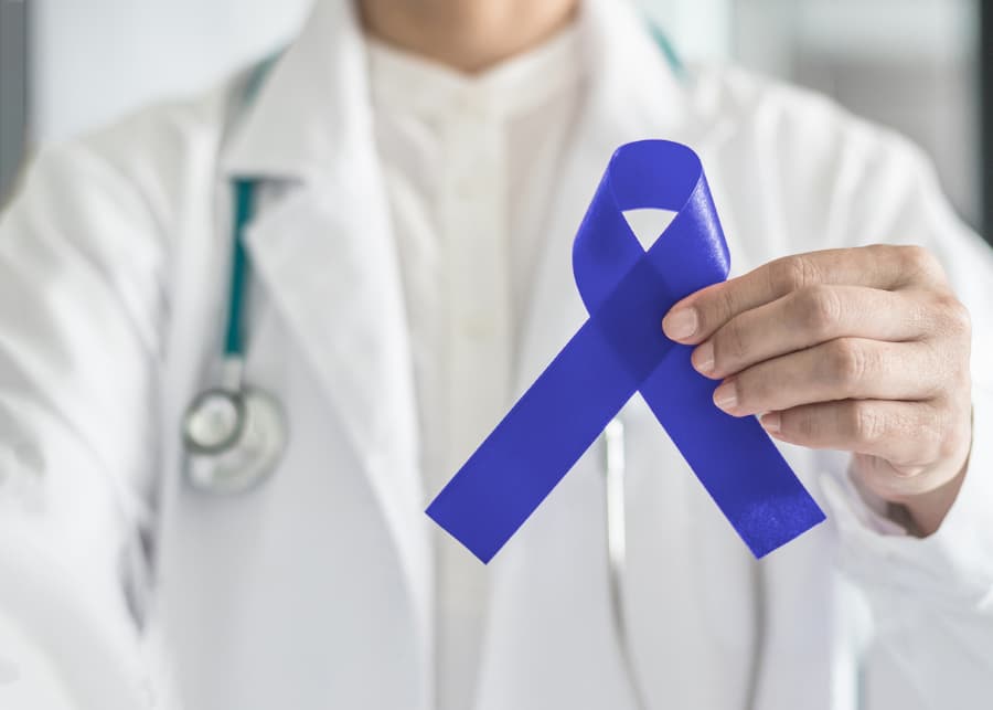 Doctor holding colon cancer awareness ribbon